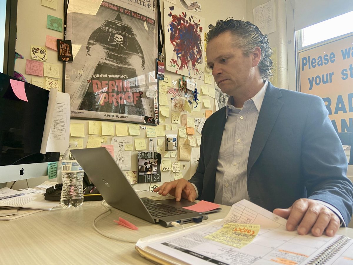 Mr. Boros checks his email at his desk in room 126. 