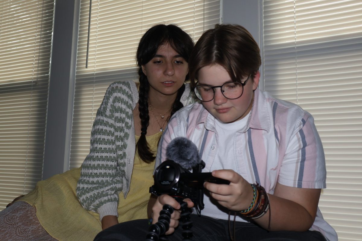 John Sheesley (right) sets up a camera while filming Rewritten with actor Lorena Rodriguez. 