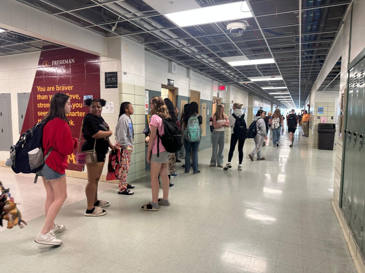 Students waiting in a line outside Women's Restroom during class change. 