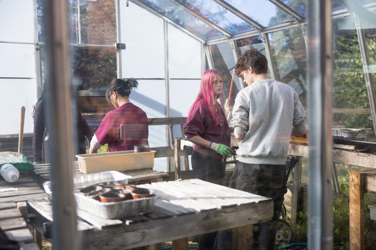 Members cleaning out the greenhouse.