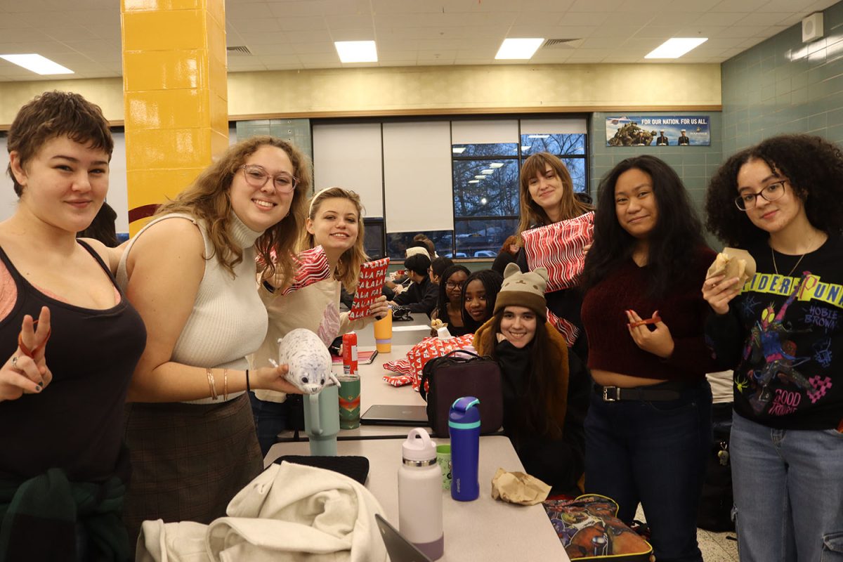 Seniors holding their donuts and keychains.