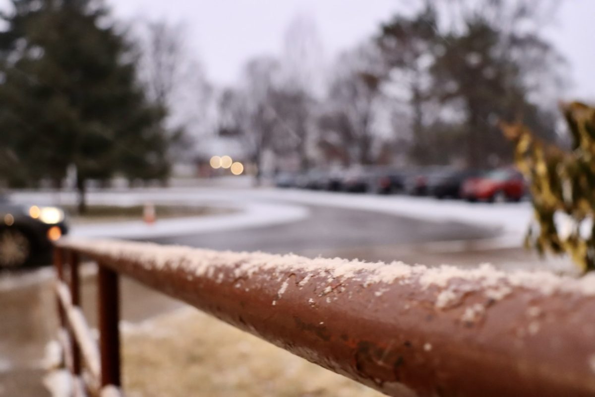 Snow accumulating on the ramp's handrails at the front circle entrance. 