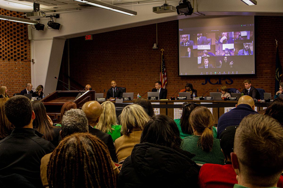 The crowd watching the board members.