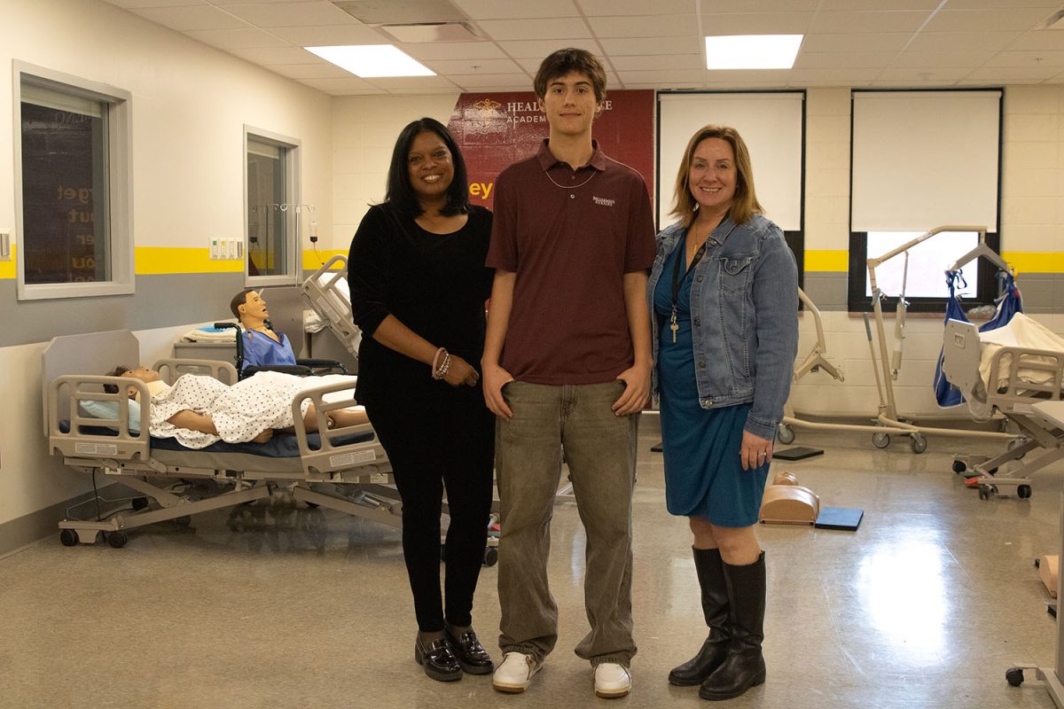 Dr. Swanson and Mrs. Harpole standing with Jagger Williams (12). 