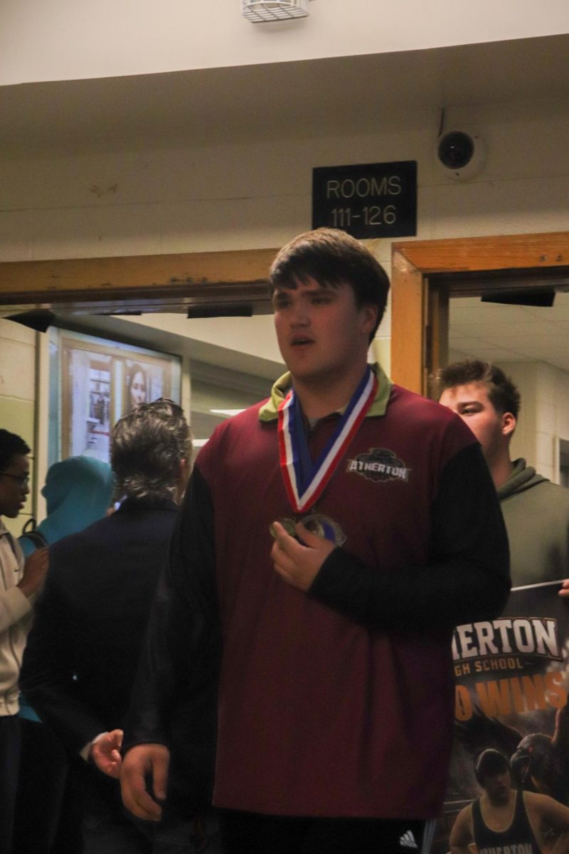 Colton Lewis (12) walking through Atherton with his state championship medal.