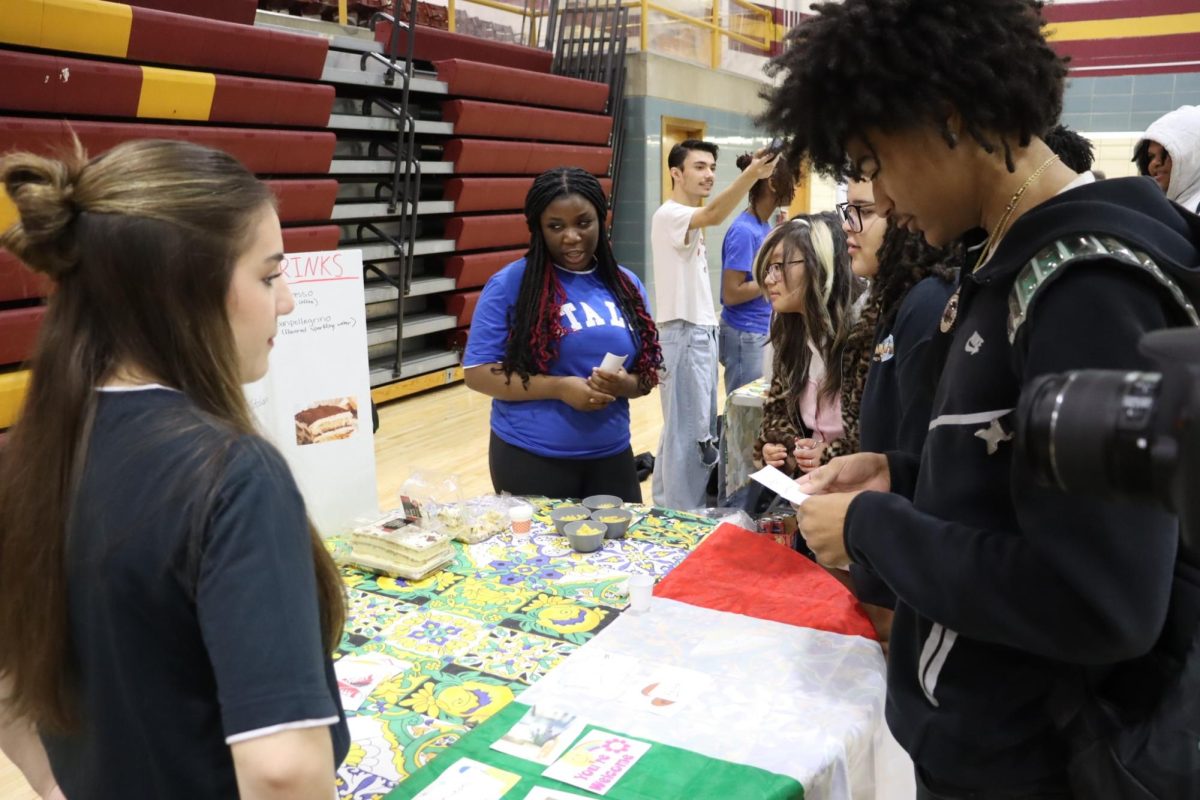 Atherton students examining the Italy booth, and learning about the culture.