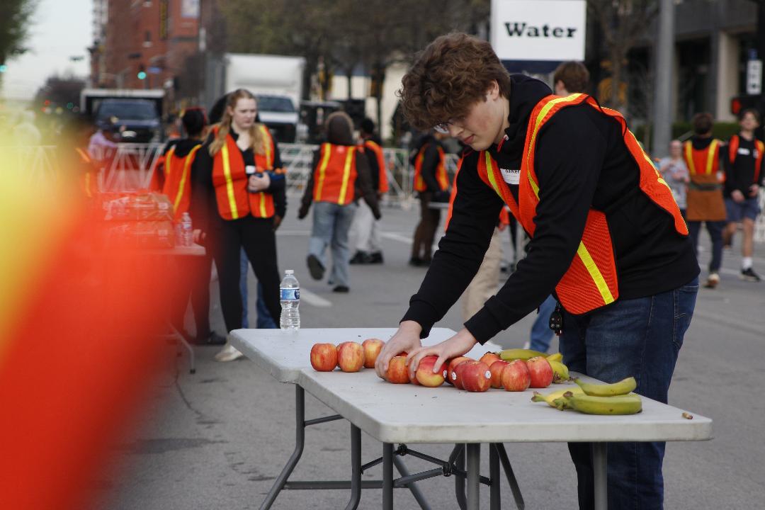 Parker Syme (12) lays out fruit for the runners. 